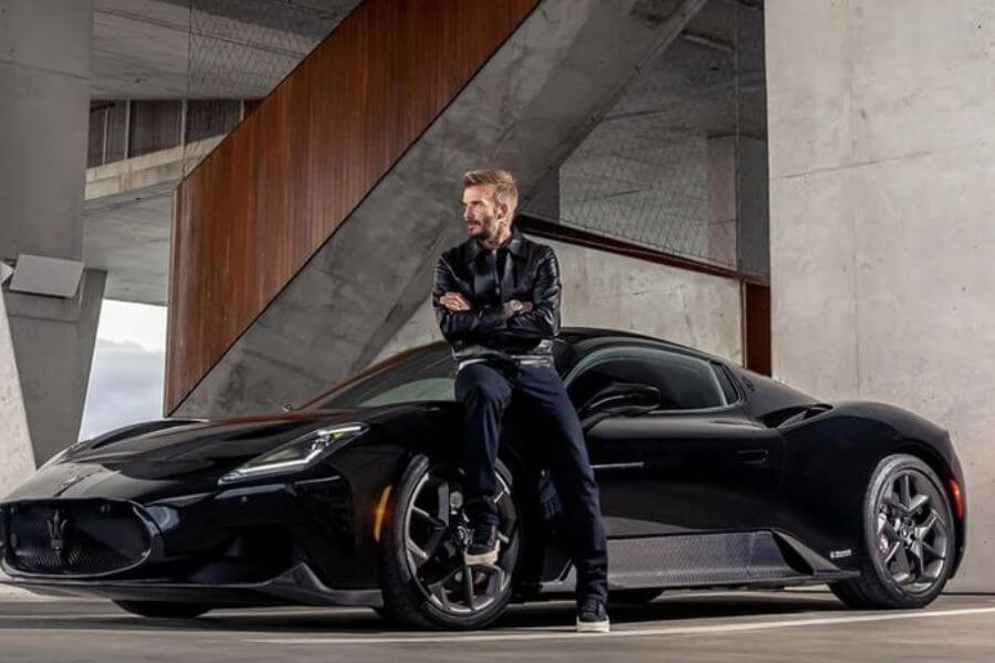 David Beckham on top of black car