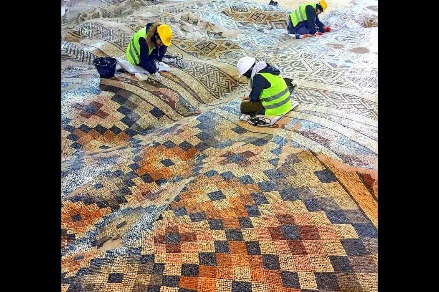 researchers working on big ancient carpet