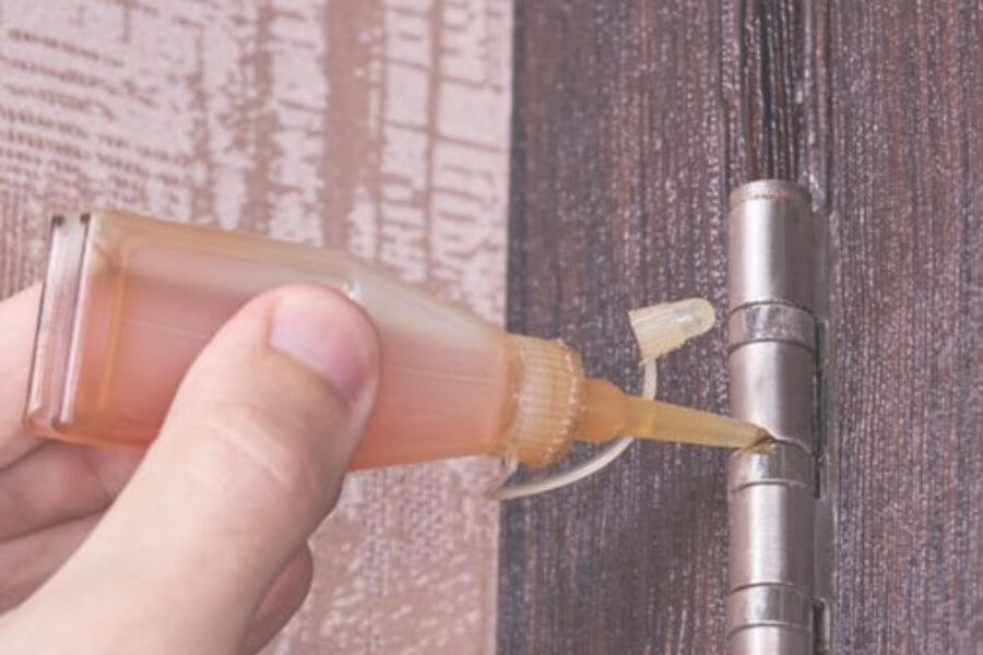 hand applying petroleum jelly on door