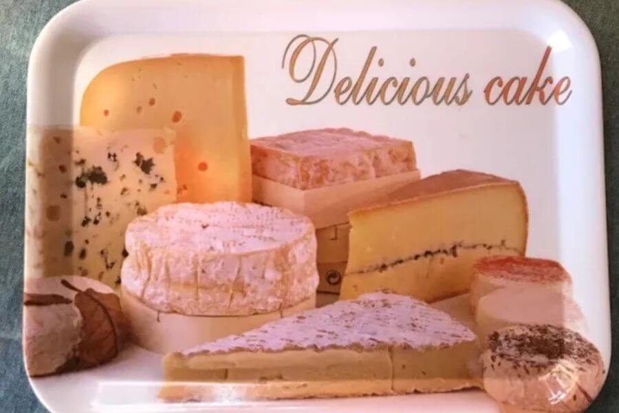 Plastic trail with text that reads "delicious cake" but has a picture of cheeses printed on it