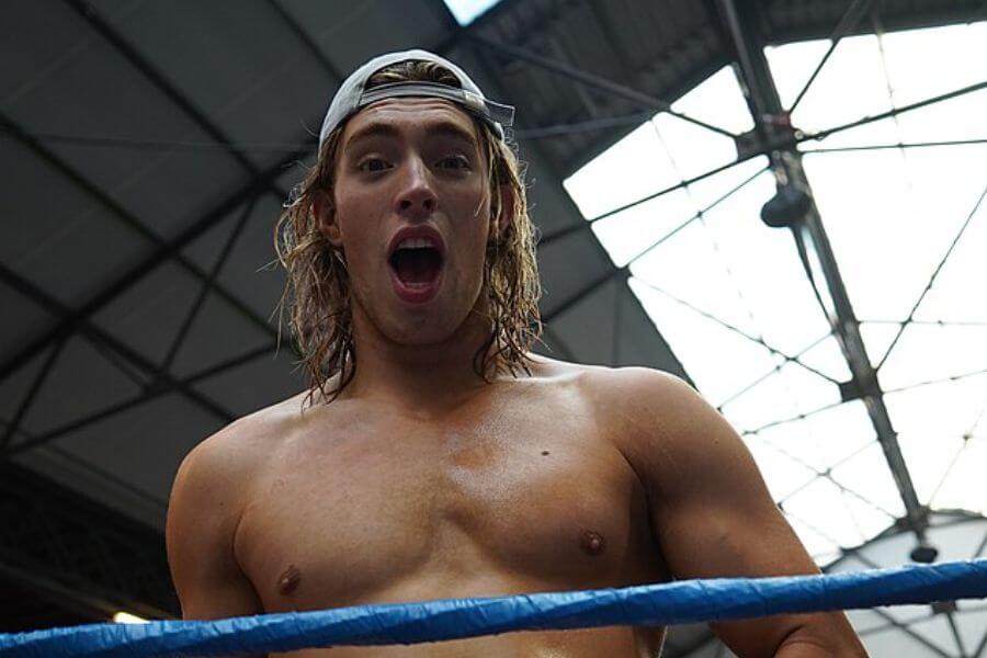 shirtless young man looking surprised