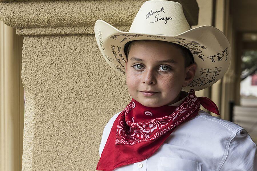 little boy wearing a cowboy hat