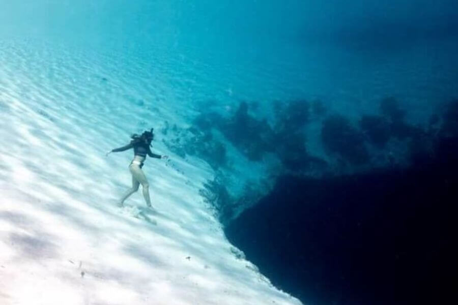 woman walking at the bottom of the ocean