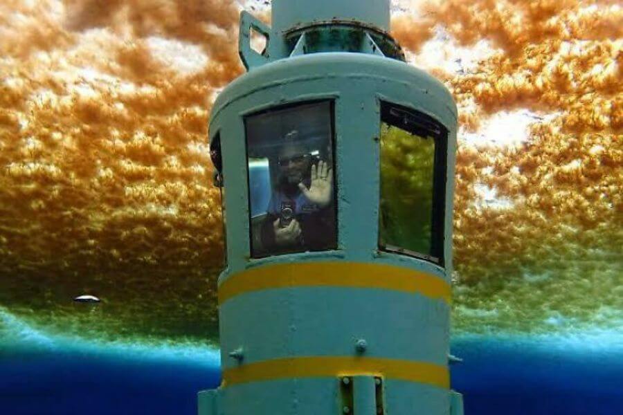 people inside a capsule below the ocean