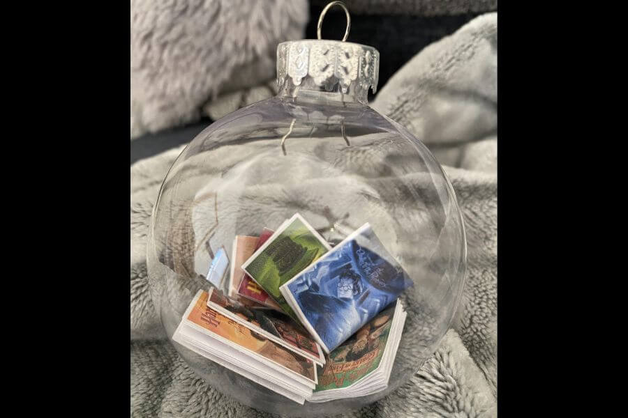 transparent christmas ornament with small books inside