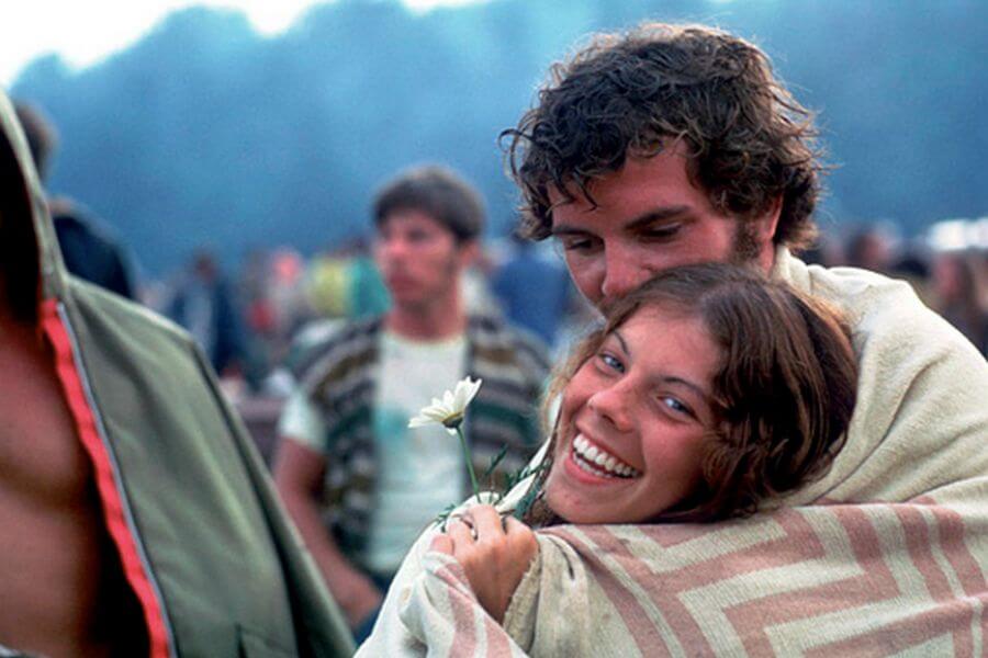 Young couple hugging at woodstock festival