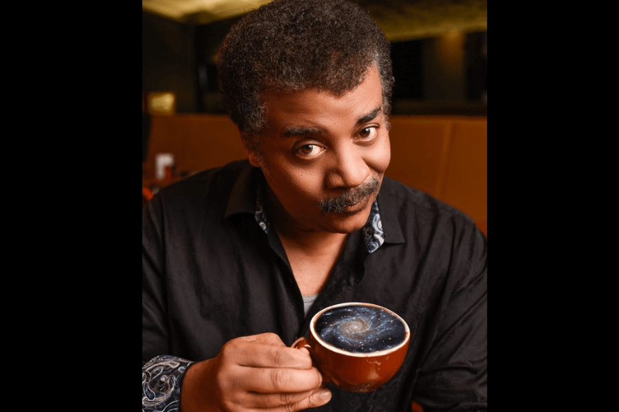 picture of a man holding a cup filled with milky way design