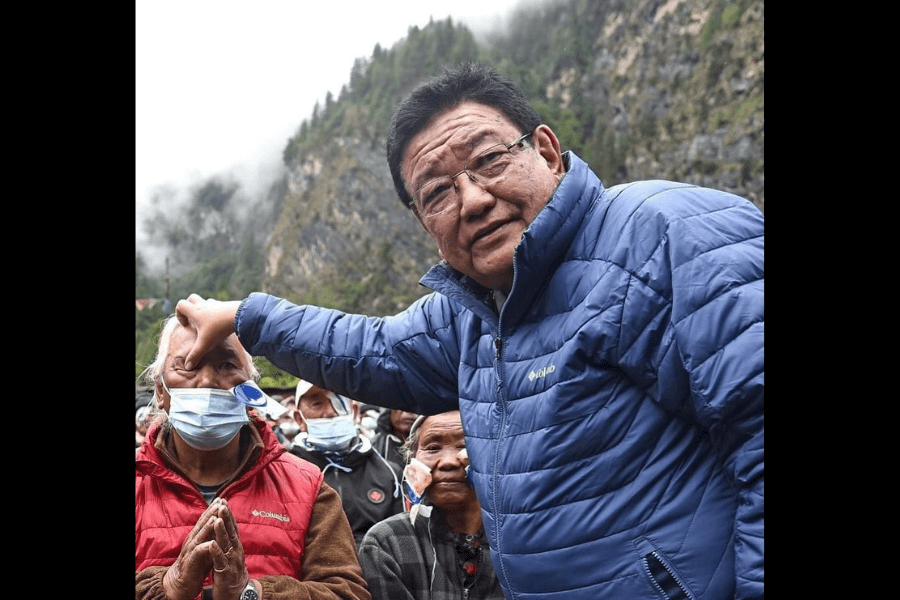 picture of a man visiting  people in the mountain and checking their eyes