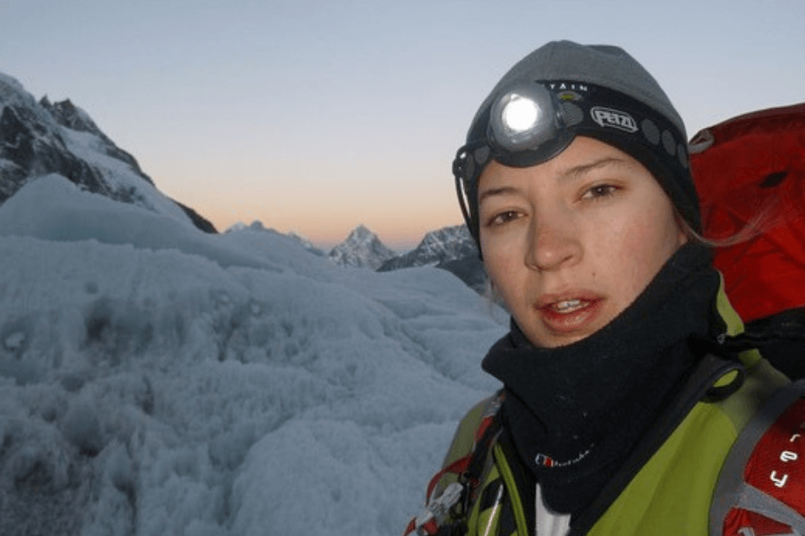 woman taking a selfie during her hike in a snowy mountain