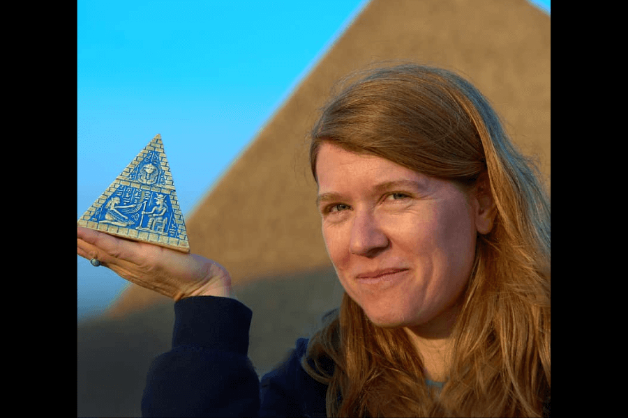 woman holding a pyramid-like figure