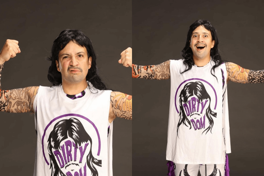 man posing with a sleeveless shirt covered with fake tattoos