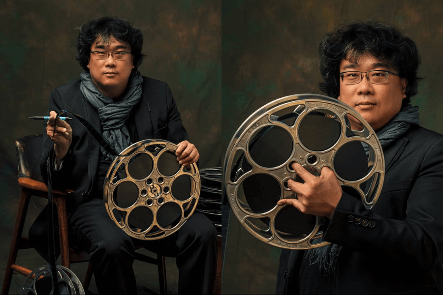 korean director posing with film strip roller