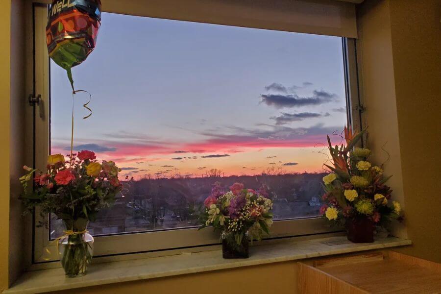 Floral arrangements next to window