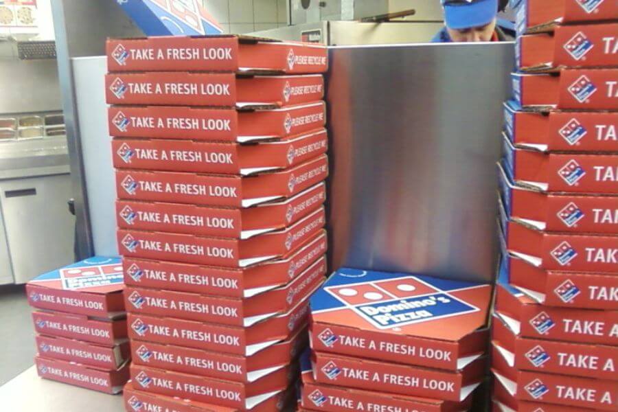 domino's pizza boxes stacked on top of eachother