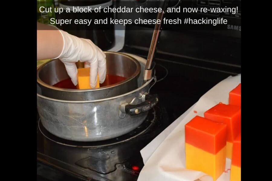 dipping cubes of cheese in wax