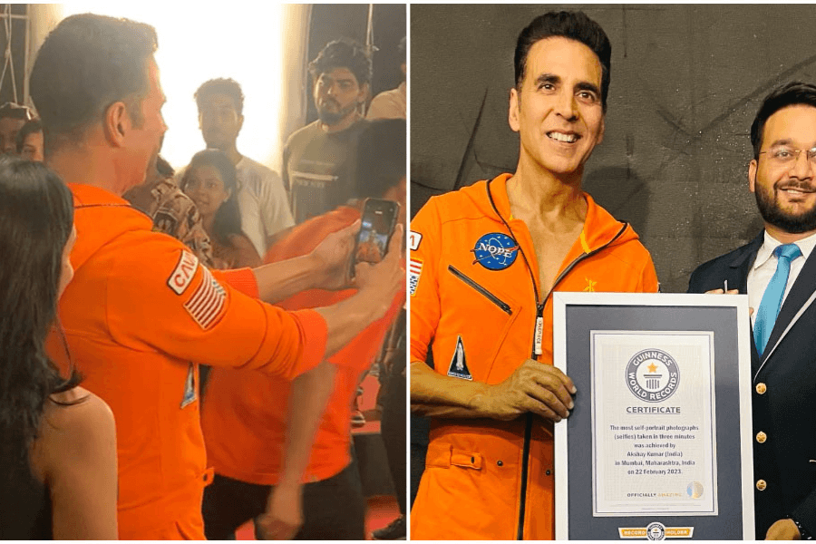 The image features a split view of an event involving a record-setting moment. On the left, a man wearing an orange jumpsuit with patches resembling a space-themed outfit is seen taking selfies with fans. On the right, the same man poses proudly with a Guinness World Records certificate alongside an official, acknowledging his achievement for "the most selfies taken in three minutes." The setting is celebratory, with the record-breaking moment clearly emphasized.