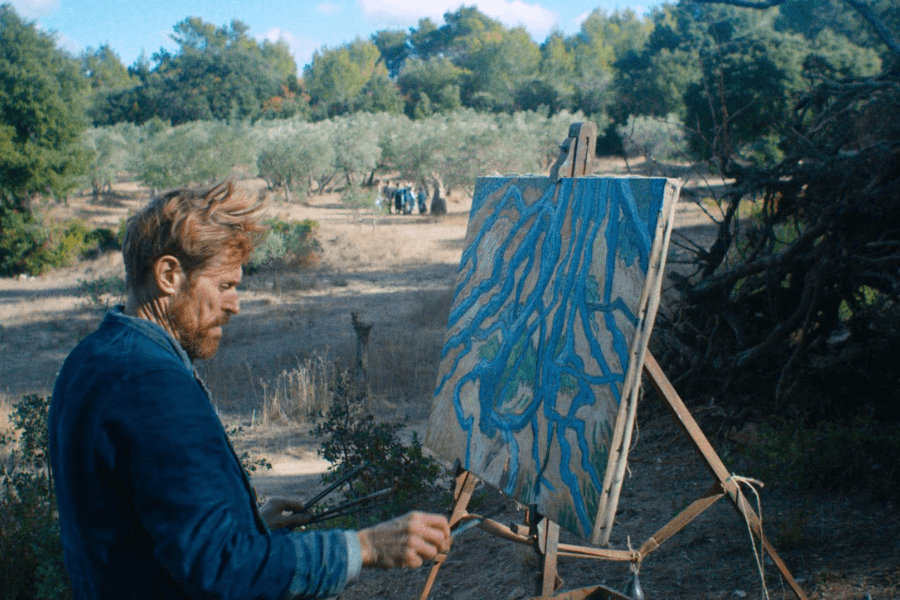 This image shows a man painting outdoors in a natural, sunlit setting with trees and shrubs in the background. The canvas on the easel features a vivid, abstract painting with branching blue lines resembling tree roots or waterways. Let me know if you'd like further details or adjustments!