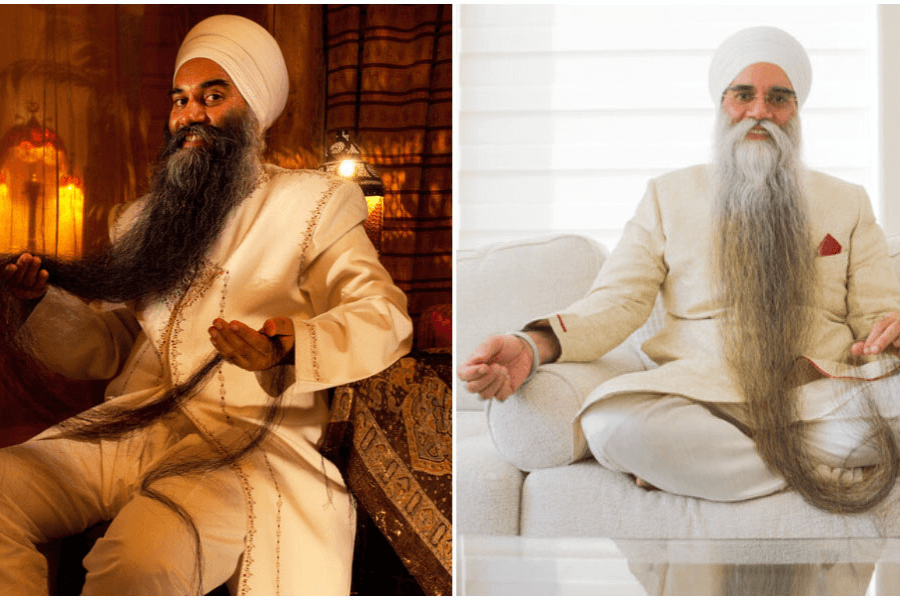 The image shows a split view of a man with an extraordinarily long beard, styled and showcased prominently. On the left, he is seated in a warmly lit room, dressed in traditional attire, holding and displaying his beard with pride. On the right, he is seated in a bright, modern setting, wearing a cream-colored suit, with his beard flowing down and resting on the couch. His serene expression in both images highlights his pride and care for his unique feature.