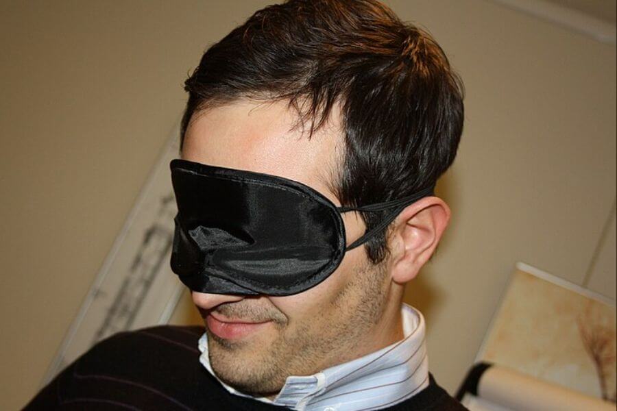 man wearing a black sleeping mask