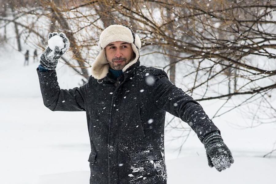 young man participating in Winter snowball game