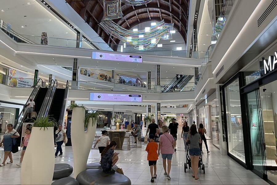 Interior of american mall. People walking around, shopping.