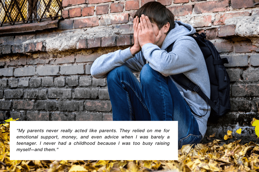 Here is the alt text for the image:

A young person wearing a gray hoodie and jeans sits on the ground against a brick wall, covering their face with their hands in distress. A black backpack rests against their back, and yellow autumn leaves are scattered around. Below the image, text reads: "My parents never really acted like parents. They relied on me for emotional support, money, and even advice when I was barely a teenager. I never had a childhood because I was too busy raising myself—and them."