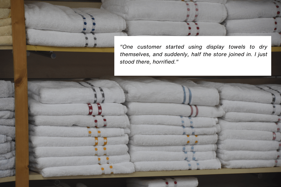 This image shows neatly folded white towels stacked on wooden shelves, some adorned with colorful stitched patterns. The quote in the image reads: "One customer started using display towels to dry themselves, and suddenly, half the store joined in. I just stood there, horrified."