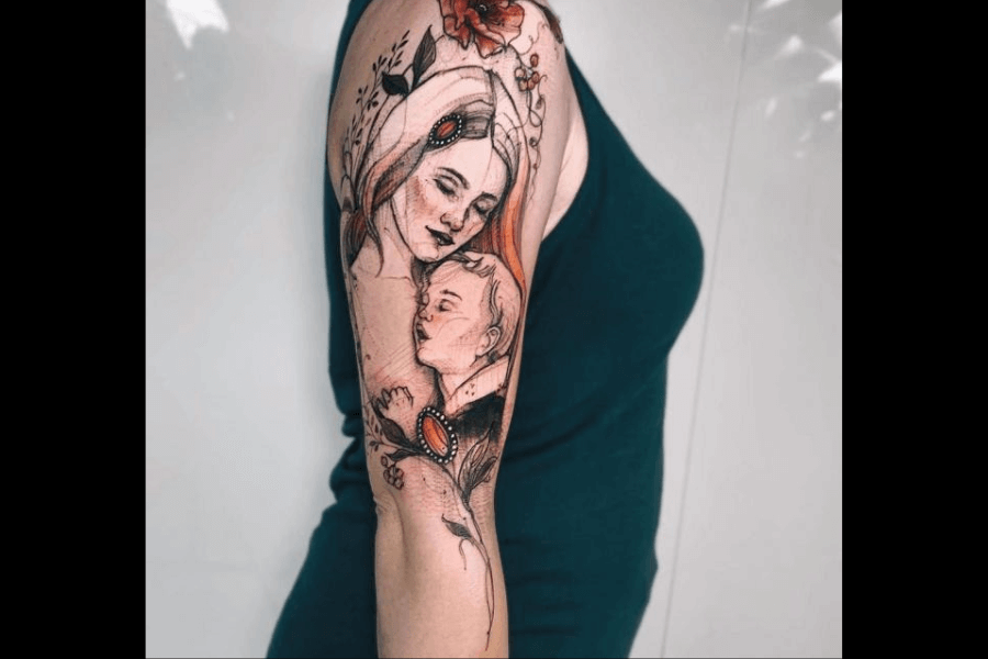 A delicate tattoo featuring a mother holding her child. The design incorporates soft, sketch-like lines with floral details, vibrant red accents, and ornamental elements for a sentimental and artistic look.