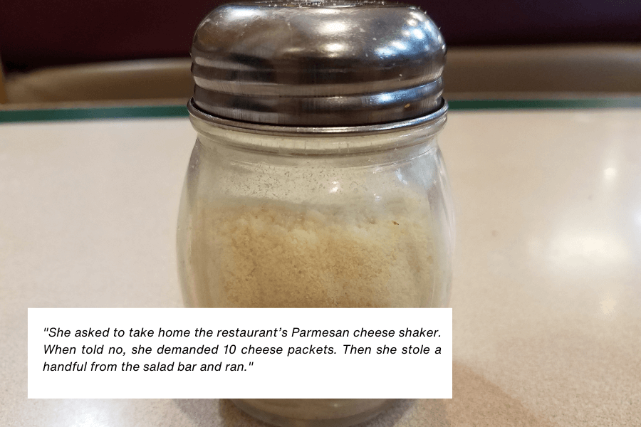 This image shows a glass Parmesan cheese shaker with a metal lid, placed on a restaurant table. The quote in the image reads: "She asked to take home the restaurant’s Parmesan cheese shaker. When told no, she demanded 10 cheese packets. Then she stole a handful from the salad bar and ran."