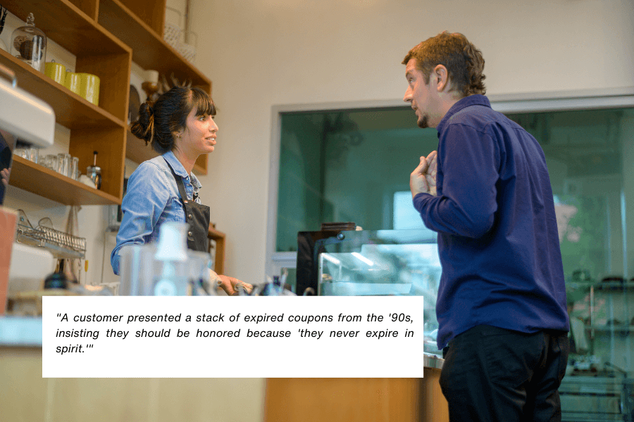 This image shows a barista in a denim apron speaking to a male customer at a café counter, with the man gesturing during their interaction. The background includes shelves with glassware and a large window providing natural light. The quote in the image reads: "A customer presented a stack of expired coupons from the '90s, insisting they should be honored because 'they never expire in spirit.'"