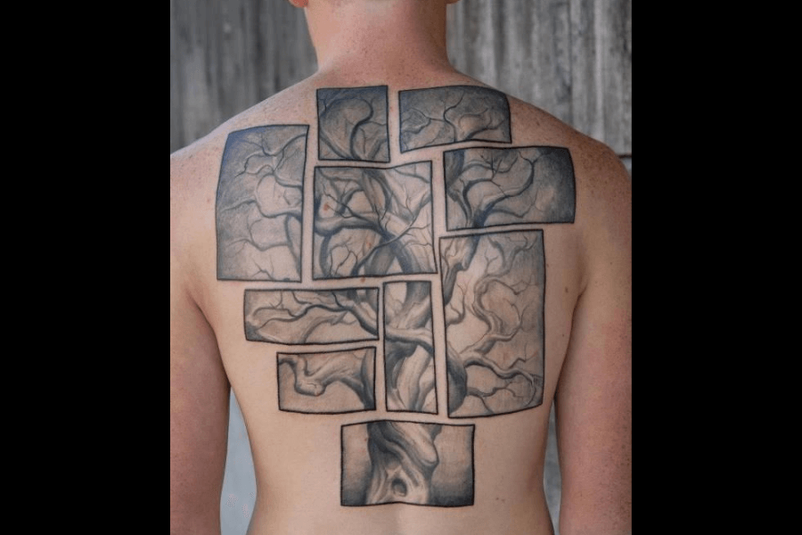 A unique back tattoo depicting a sprawling tree with intertwining branches, divided into multiple rectangular panels. The design creates a fragmented yet cohesive appearance, with soft shading and intricate linework adding depth and texture. The tree spans the entire back, blending organic shapes with a geometric layout for a modern artistic effect.