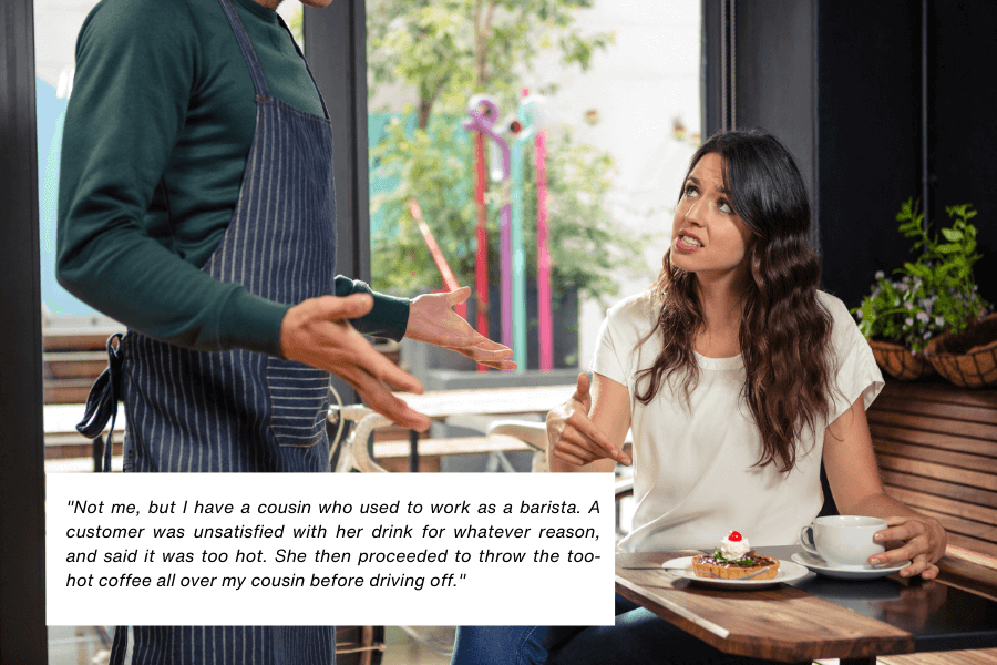 This image shows a barista wearing an apron gesturing while speaking to a seated customer, a woman with long dark hair, who appears frustrated or upset. She has a plate with a pastry and a cup of coffee in front of her on the table. The quote in the image reads: "Not me, but I have a cousin who used to work as a barista. A customer was unsatisfied with her drink for whatever reason, and said it was too hot. She then proceeded to throw the too-hot coffee all over my cousin before driving off."