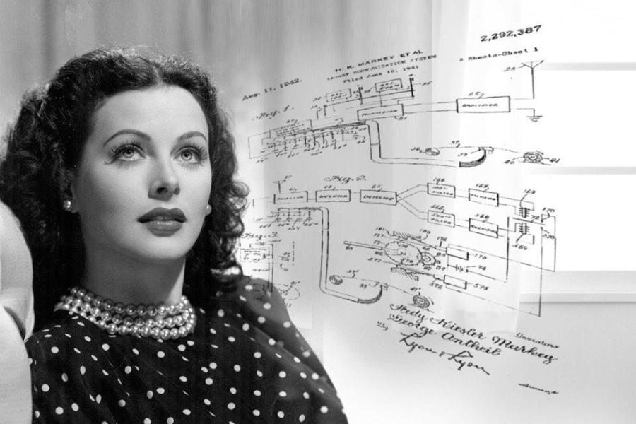  A black-and-white portrait of a woman with dark wavy hair and elegant makeup, gazing upward with a thoughtful expression. She wears a pearl necklace and a polka-dot dress, exuding classic Hollywood glamour. Overlaid on the image is a vintage patent schematic with detailed technical drawings, symbolizing her contributions to innovation.