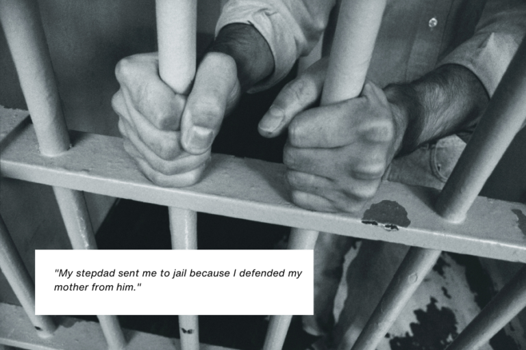 A black-and-white image shows a person gripping the bars of a jail cell tightly with both hands. Their shirt and the grim surroundings convey a sense of confinement and despair. Below the image, text reads: "My stepdad sent me to jail because I defended my mother from him."