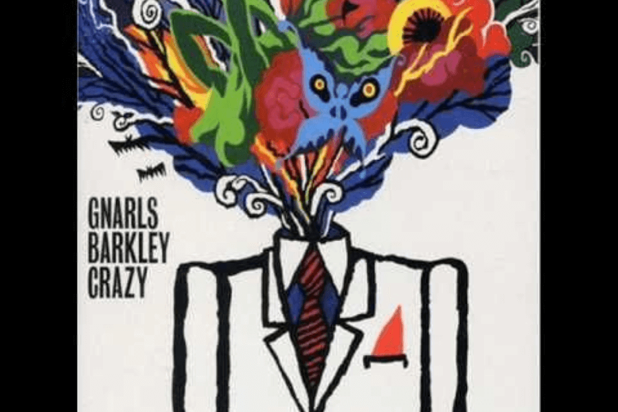 A surreal illustration of a faceless figure in a black-and-white suit with a red tie, with an explosion of colorful abstract shapes, creatures, and patterns emerging from where the head should be. The artwork includes bold blues, reds, yellows, and greens, giving it a psychedelic and chaotic feel. The text "Gnarls Barkley Crazy" appears on the left side, indicating it is related to the song or album.