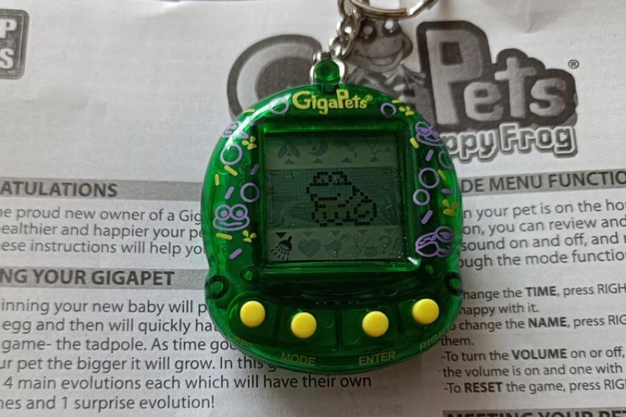 pocket-sized, brightly colored digital pet with a tiny pixelated screen and three buttons