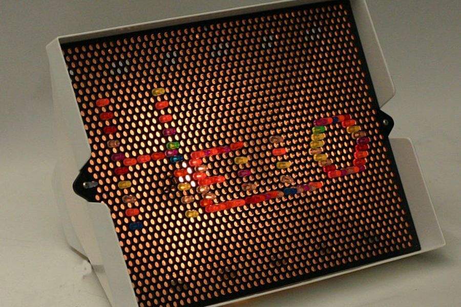 The word "hello" written of a lite-brite board