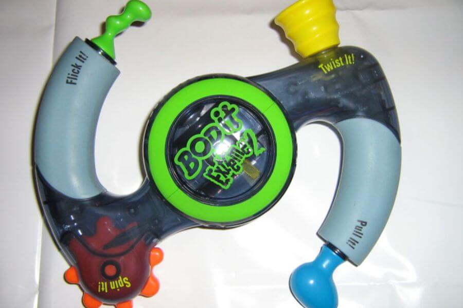 Boomerang shaped plastic toy that reads "bop it" right in the middle 