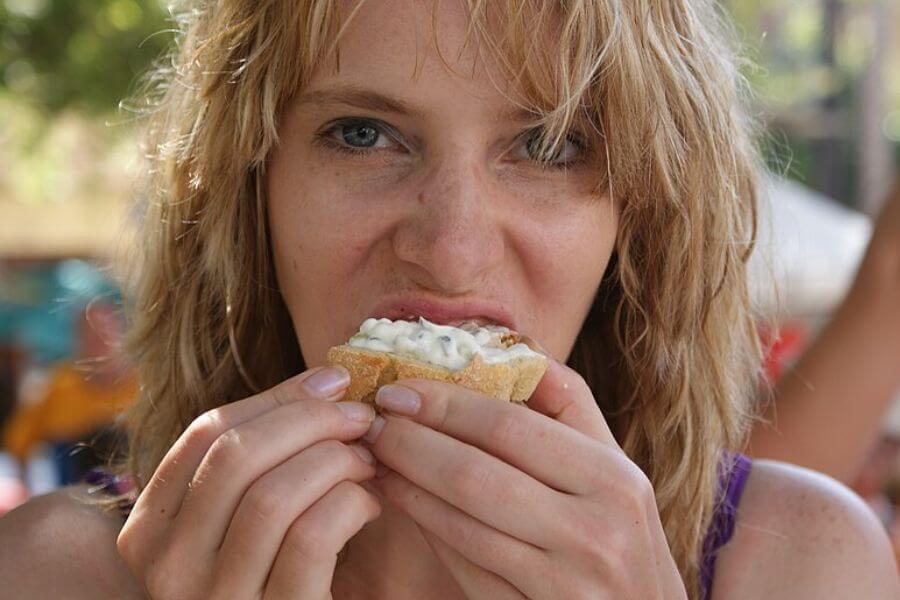 close up of a young attractive blonde woman eating