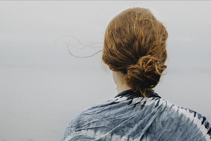 The back of the head of a Woman red hair looking at sky