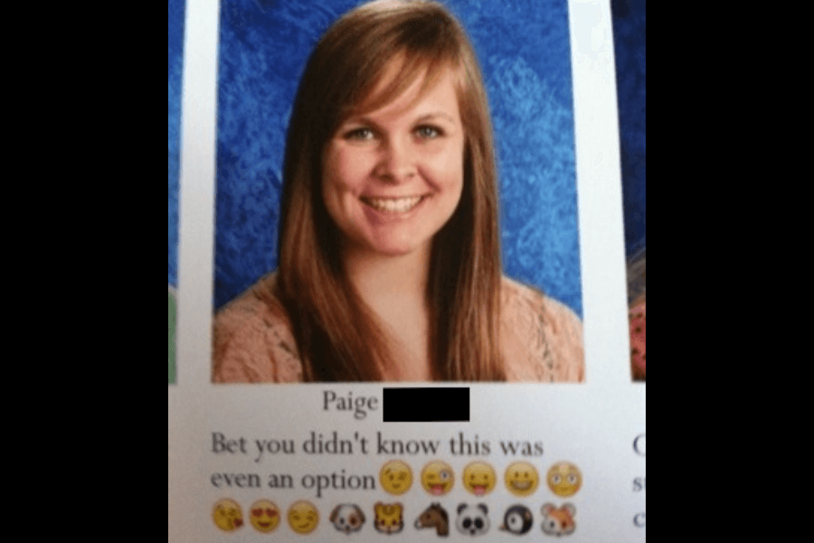 A high school yearbook photo of a smiling young woman with long, straight brown hair, wearing a light-colored top against a blue background. Below her name, the yearbook quote reads, "Bet you didn't know this was even an option," followed by a series of various emojis, including smirking faces, animals, and a skull.