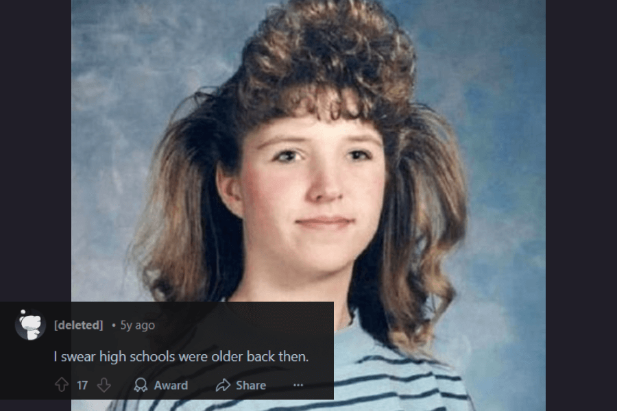 A vintage school portrait of a young girl with an exaggerated 1980s hairstyle featuring voluminous, teased bangs and feathered layers that extend outward. She wears a striped shirt and has a neutral, slightly awkward expression. A humorous comment below jokes about how high school students looked older in past decades.