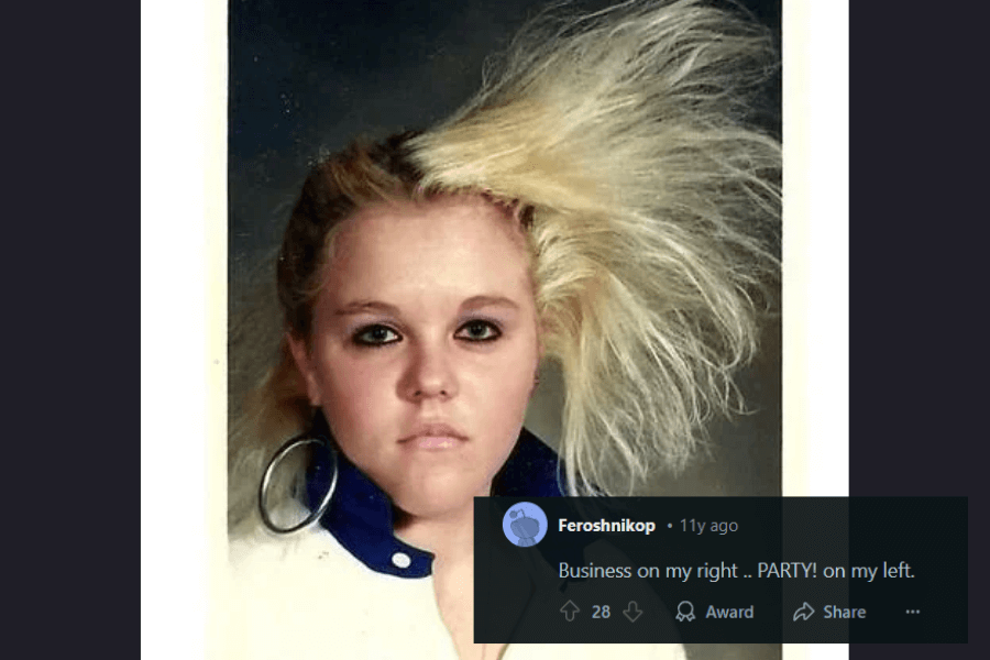 A vintage portrait of a young woman with a dramatically asymmetrical hairstyle—her right side sleek and flat, while the left side is wildly teased and voluminous. She wears dark eyeliner, oversized hoop earrings, and a collared white jacket with blue trim, exuding an intense 80s aesthetic. A humorous caption below describes the look as “Business on my right… PARTY! on my left.”