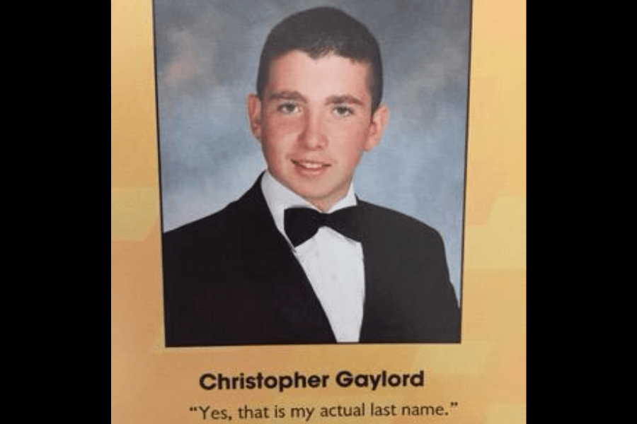 A high school yearbook photo of Christopher Gaylord, a young man dressed in a black tuxedo with a bow tie, smiling at the camera against a neutral gray background. Below his name, his humorous yearbook quote reads, "Yes, that is my actual last name," playfully addressing any potential reactions to his surname.