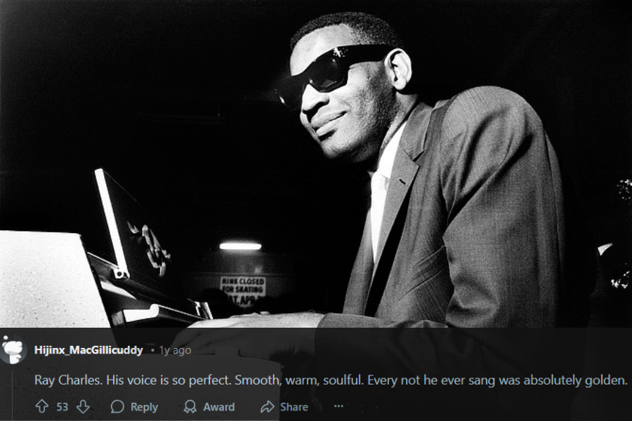 A black and white photograph of a pianist wearing dark sunglasses and a suit, playing an electric keyboard with a confident smile. The lighting casts a dramatic contrast, highlighting his expressive face and hands on the keys. A sign in the background reads "RINK CLOSED FOR SKATING," adding a subtle atmospheric detail.