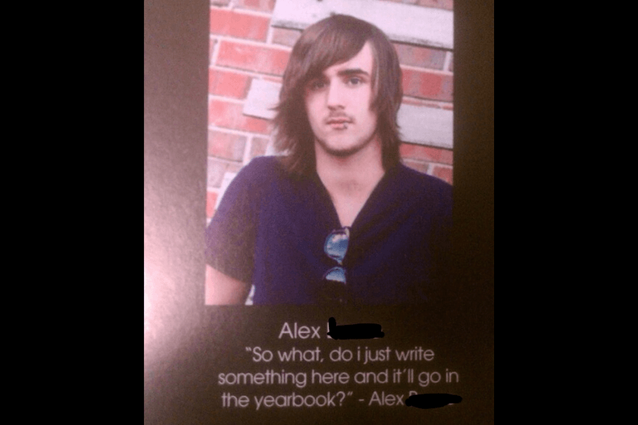 A high school yearbook photo of Alex [last name redacted], a young man with long brown hair, wearing a dark-colored V-neck shirt with sunglasses hanging from his collar, standing against a brick wall. Below his name, his humorous and self-aware yearbook quote reads, "So what, do I just write something here and it’ll go in the yearbook?"