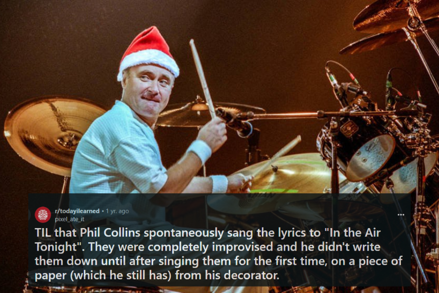 A drummer wearing a Santa hat performs on stage, smiling while mid-action with drumsticks in hand. He is surrounded by an elaborate drum kit with cymbals, microphones, and stands, creating a festive and energetic atmosphere. The warm stage lighting enhances the celebratory mood of the performance.