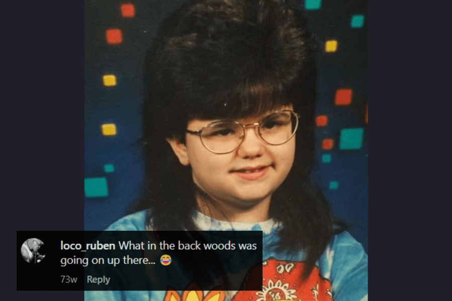 A school portrait of a young girl with an exaggerated, voluminous 80s-style bouffant haircut that towers over her head. She wears large round glasses and a colorful, patterned shirt, smiling slightly against a retro geometric backdrop. A humorous comment at the bottom questions the dramatic height of her hair.