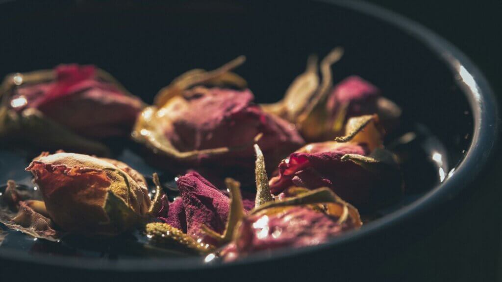 Miniature pink roses arranged in a decorative bowl