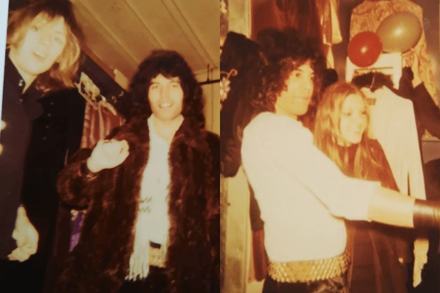 Two side-by-side vintage snapshots of Freddie Mercury in casual backstage moments. On the left, he stands smiling in a brown fur coat next to a blonde-haired man. On the right, he poses with a woman among coats and balloons, dressed in a white top and studded gold belt, his arm outstretched as if gesturing or pointing.